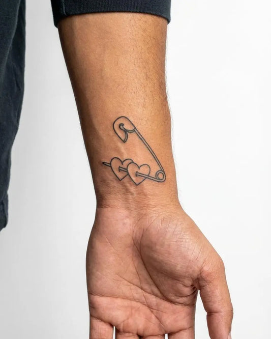 INKON Safety Pin & Hearts semi-permanent tattoo applied on a man – 2 x 2 in (5x5cm) design, realistic ink look, lasts 10 days
