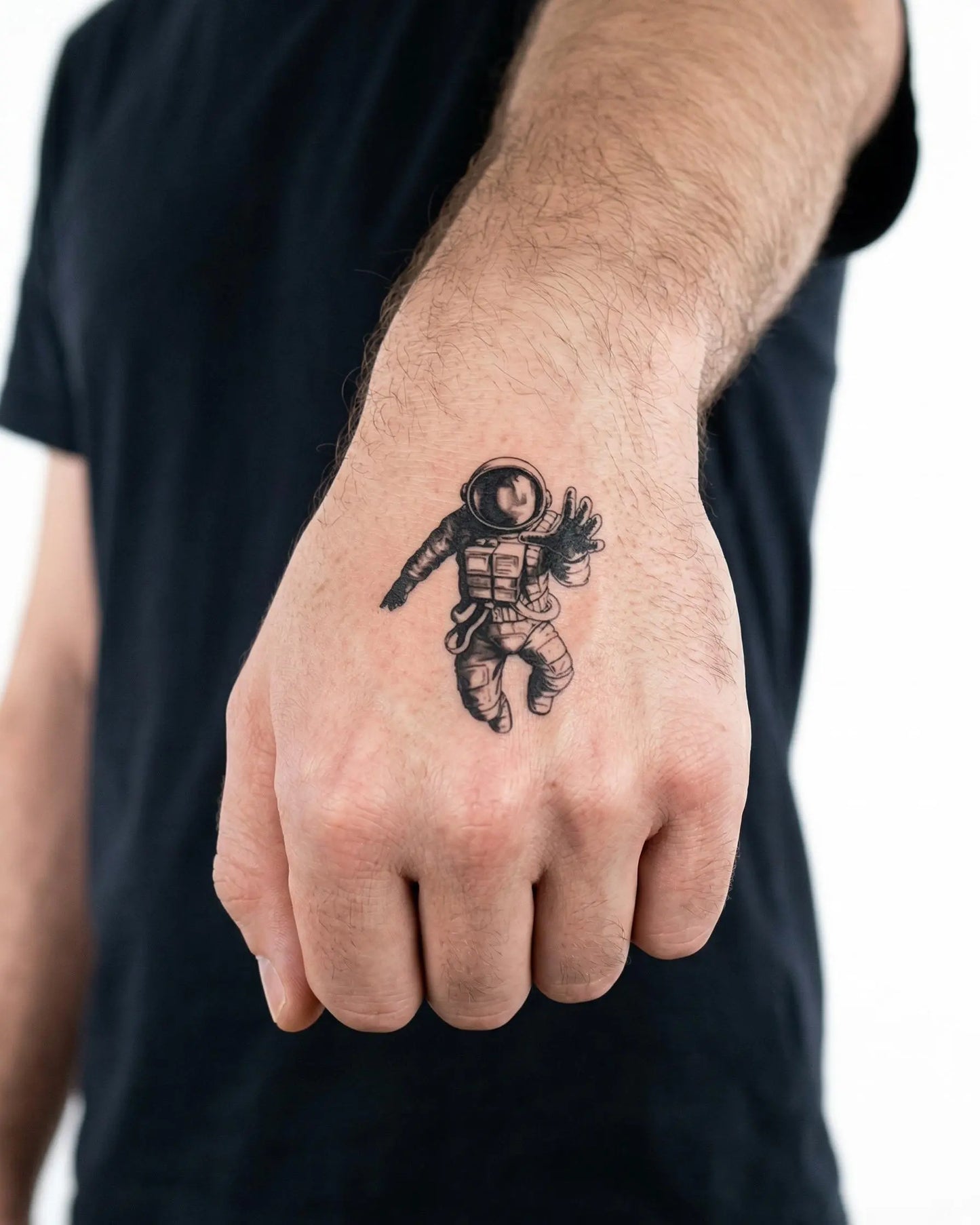 INKON Floating Astronaut semi-permanent tattoo applied on a man – 2 x 2 in (5x5cm) design, realistic ink look, lasts 10 days